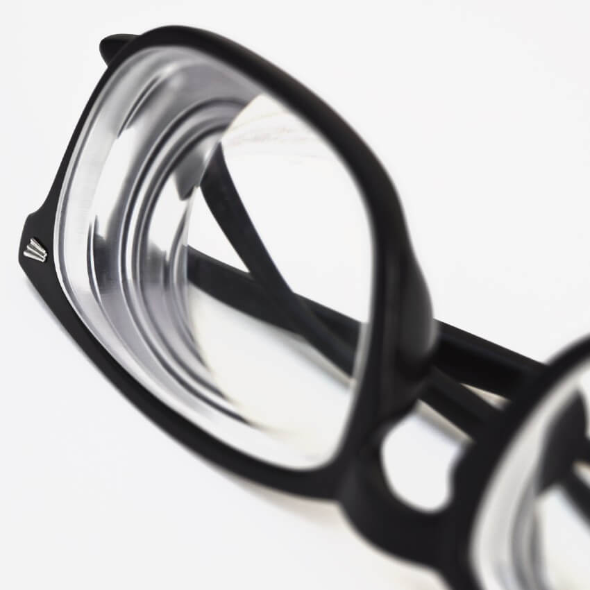 Black prescription eyeglasses with thick frames and clear lenses.
