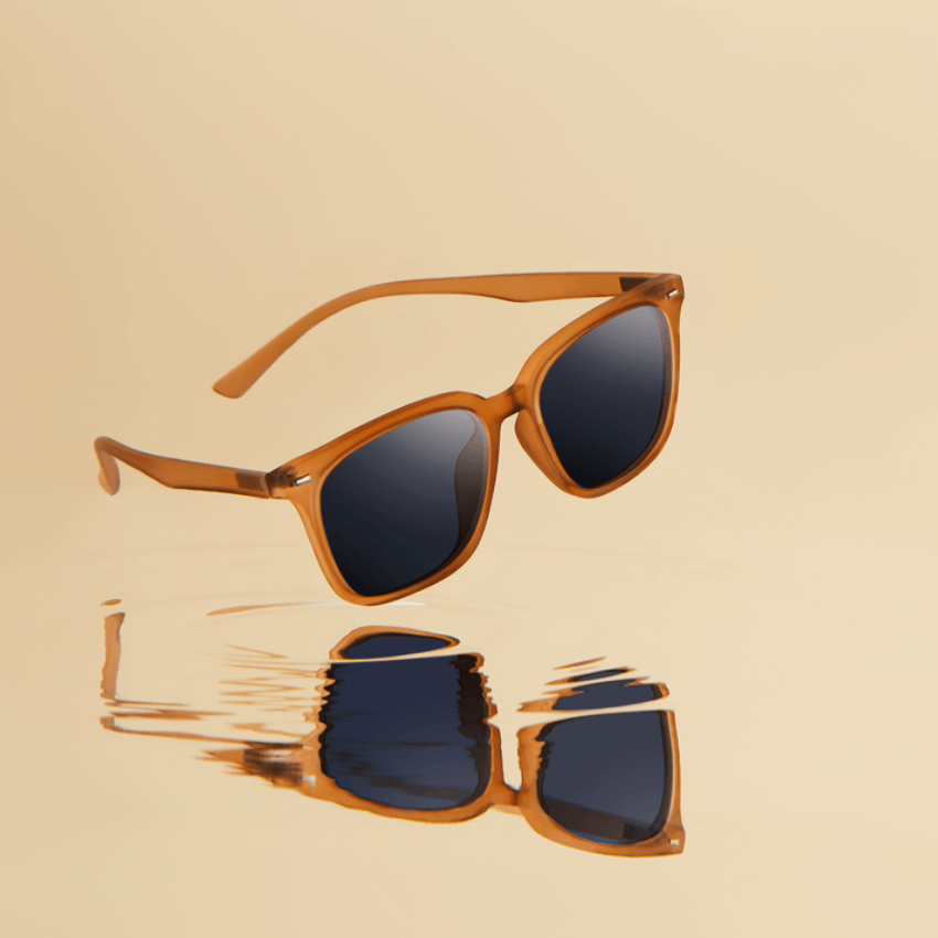 Brown-framed sunglasses with dark lenses, reflected on a mirrored surface.