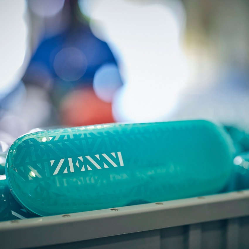 Teal glasses case with the text "ZENNI" in white.