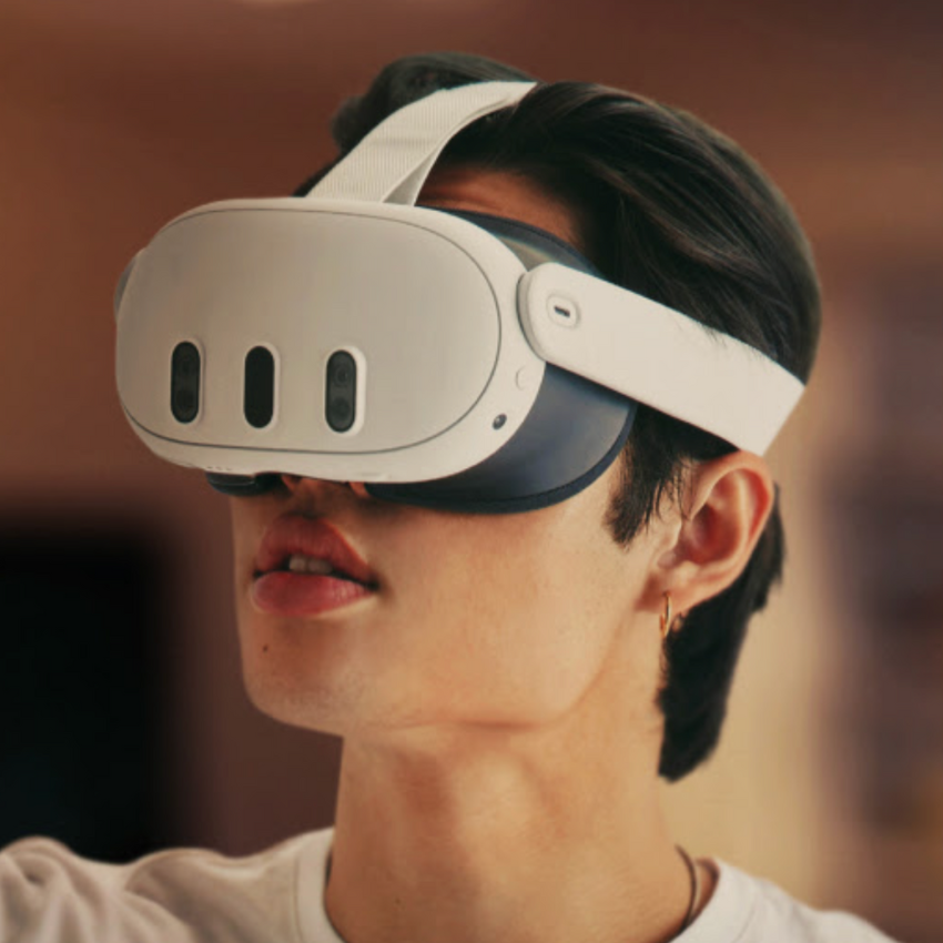 Person wearing white VR headset with black sensors and a white head strap.