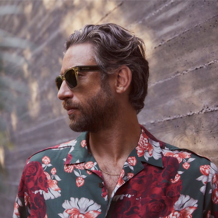Man wearing ZIONTI sunglasses and a floral shirt.