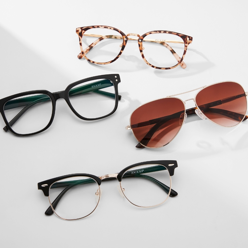 Four pairs of glasses: tortoiseshell, black-rimmed, aviator sunglasses, and half-rimmed retro style, all branded 'ZANNI S.'